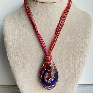 Art Glass Pendant Necklace in red blue and gold on colorful multi strand cord